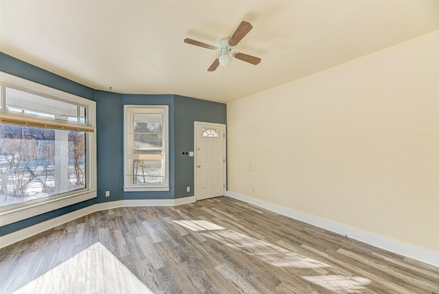 420 Knight St, Helena, MT 59601 - unfurnished room with wood finished floors, a ceiling fan, and baseboards