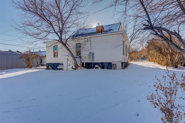 420 Knight St, Helena, MT 59601 - snow covered house with stucco siding and a chimney