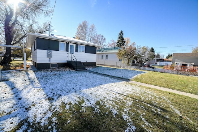 back of house featuring a yard