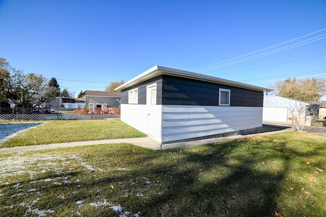 view of side of home with a lawn