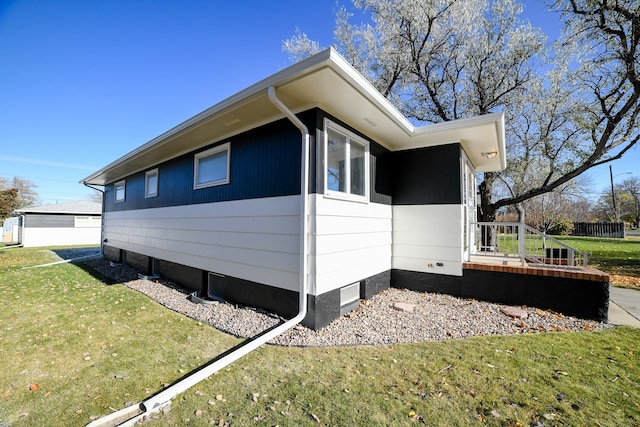 view of side of property with a lawn