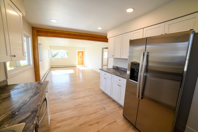 kitchen with light hardwood / wood-style flooring, dark stone counters, stainless steel fridge with ice dispenser, and white cabinets