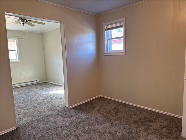 unfurnished room with baseboard heating, ornamental molding, ceiling fan, and dark carpet