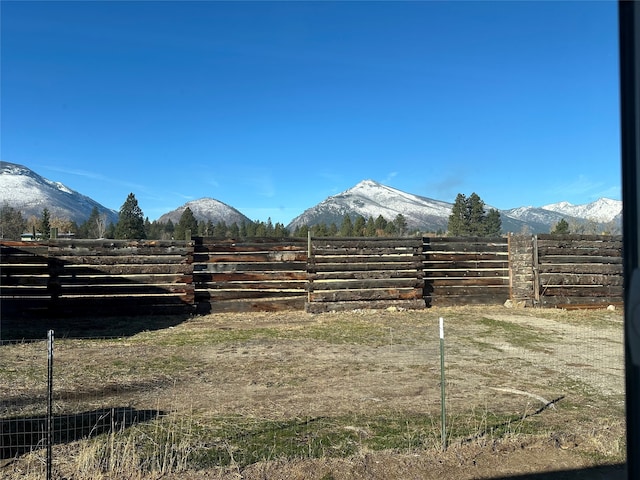 view of yard with a mountain view and a rural view