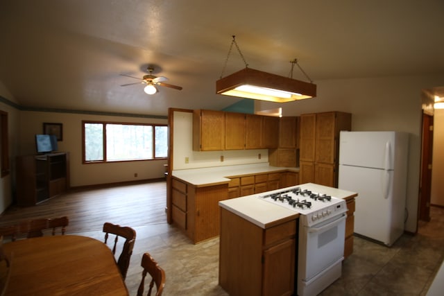 kitchen with ceiling fan, white appliances, light hardwood / wood-style flooring, a center island, and vaulted ceiling