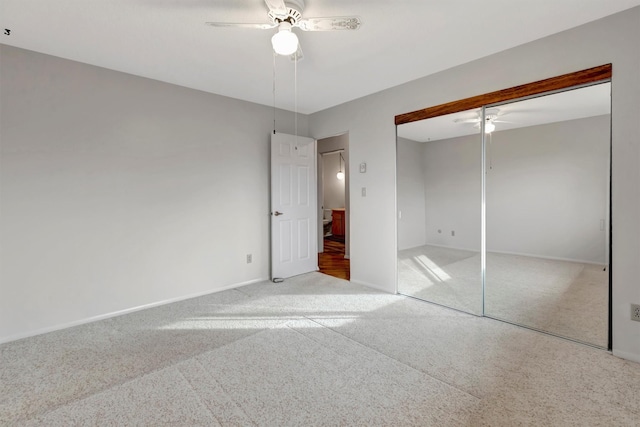 unfurnished bedroom with a closet, baseboards, a ceiling fan, and carpet