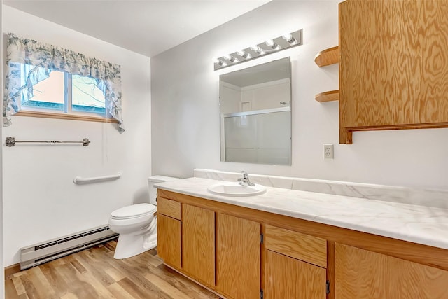 full bathroom featuring vanity, wood finished floors, baseboard heating, toilet, and a shower with door