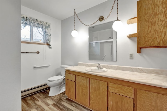 bathroom featuring a shower with door, vanity, hardwood / wood-style flooring, a baseboard radiator, and toilet