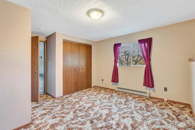 unfurnished bedroom featuring baseboards, carpet floors, a closet, a textured ceiling, and a baseboard radiator