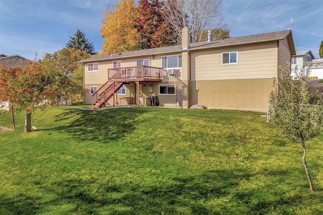 back of property featuring a deck and a yard