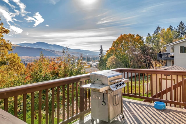 wooden terrace with a mountain view and area for grilling