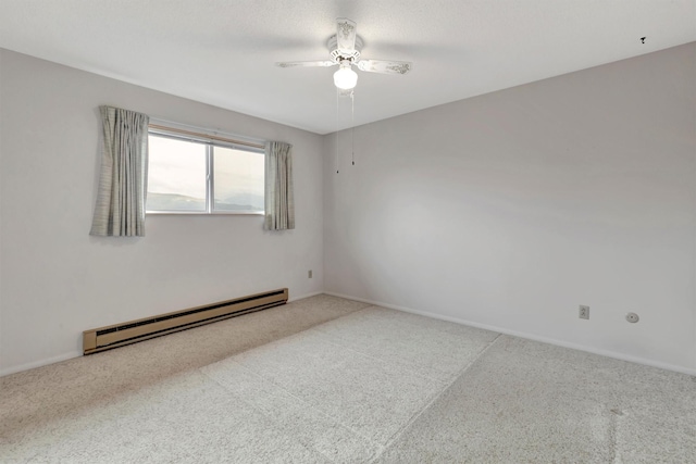 carpeted spare room featuring a baseboard heating unit, baseboards, and a ceiling fan
