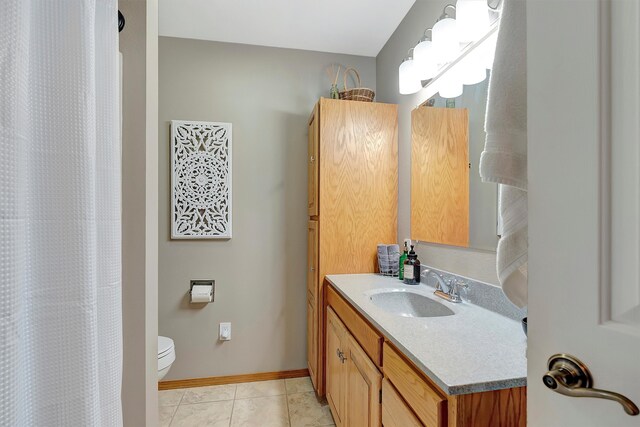 bathroom with vanity, tile patterned floors, toilet, and a shower with curtain