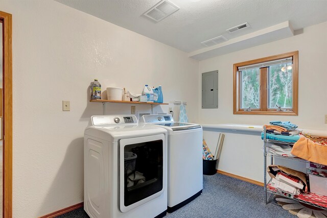 laundry area with electric panel, washing machine and dryer, a textured ceiling, and carpet