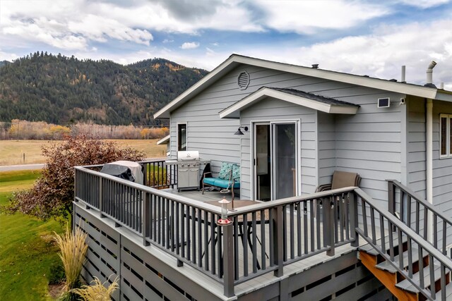 wooden deck with a mountain view