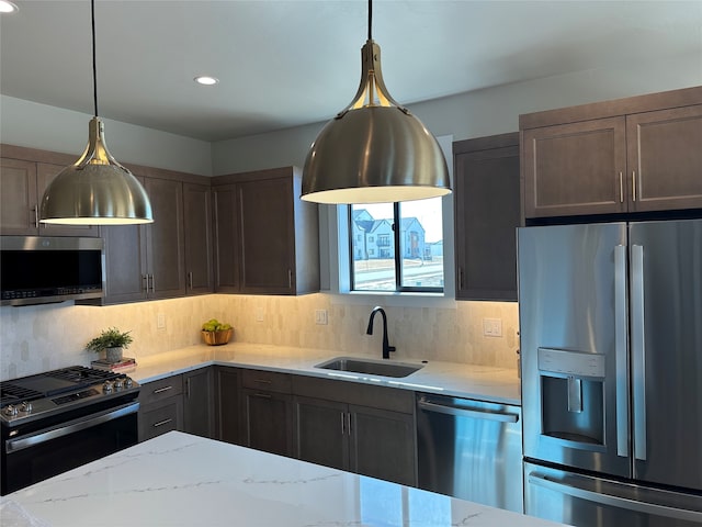 179 E Monture Rdg, Kalispell, MT 59901 - kitchen featuring appliances with stainless steel finishes, light stone countertops, tasteful backsplash, and recessed lighting