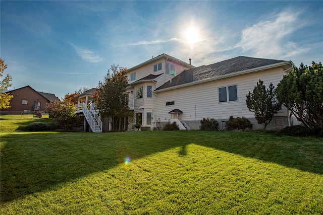 back of property featuring a lawn