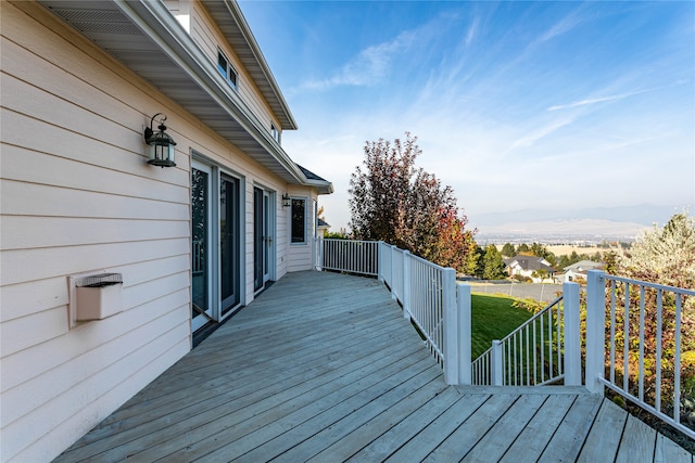 wooden terrace with a yard