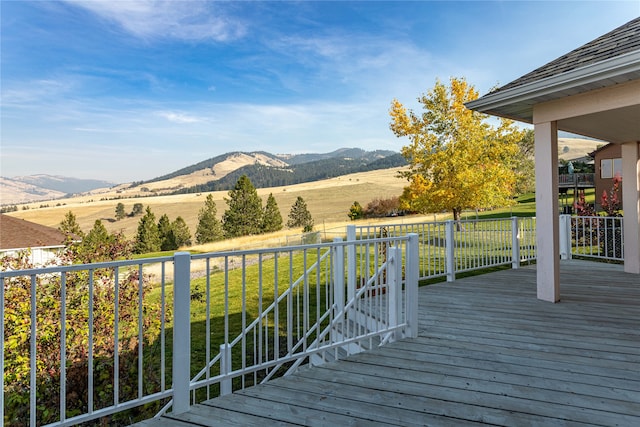 wooden terrace featuring a mountain view and a rural view