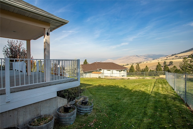 view of yard featuring a deck with mountain view