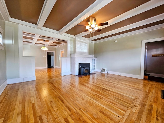 unfurnished living room featuring ceiling fan, beamed ceiling, and light hardwood / wood-style flooring