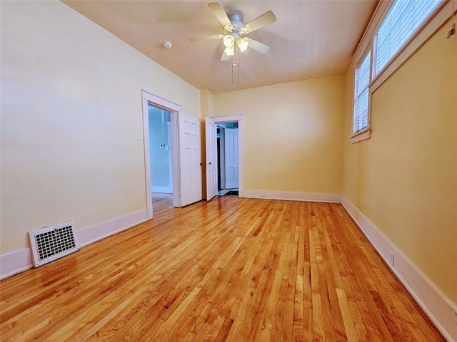 spare room with light hardwood / wood-style flooring and ceiling fan