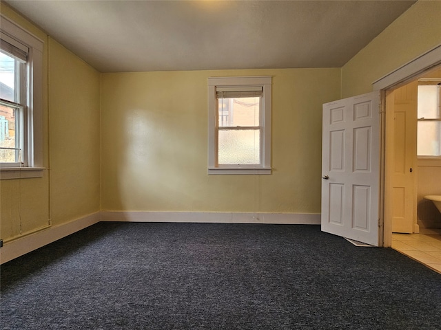 carpeted empty room with plenty of natural light