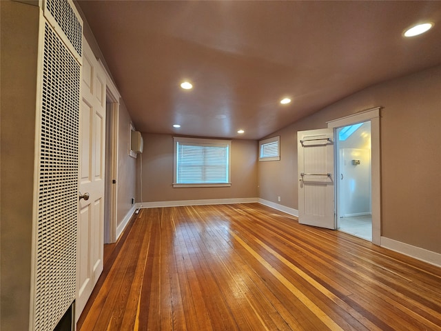 interior space with hardwood / wood-style floors, a closet, and a wall mounted air conditioner