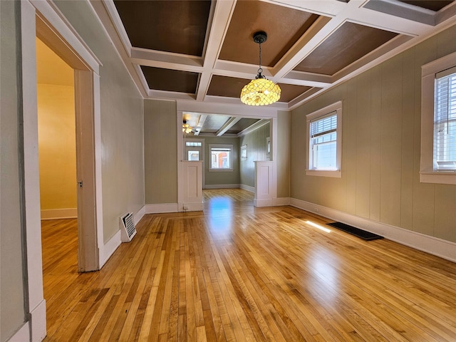 interior space featuring light hardwood / wood-style flooring, beam ceiling, crown molding, and coffered ceiling