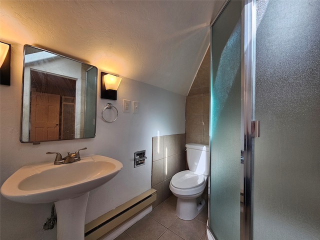 bathroom featuring tile walls, tile patterned floors, a textured ceiling, vaulted ceiling, and baseboard heating