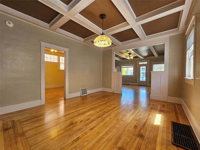 unfurnished room featuring light hardwood / wood-style floors, beamed ceiling, ceiling fan, and coffered ceiling