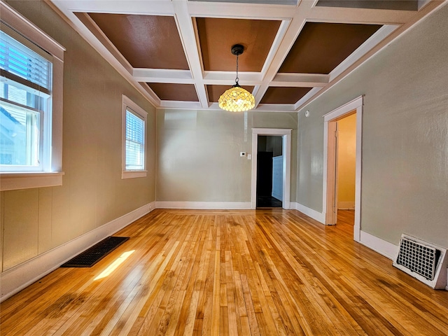 unfurnished room featuring hardwood / wood-style floors, beam ceiling, and coffered ceiling