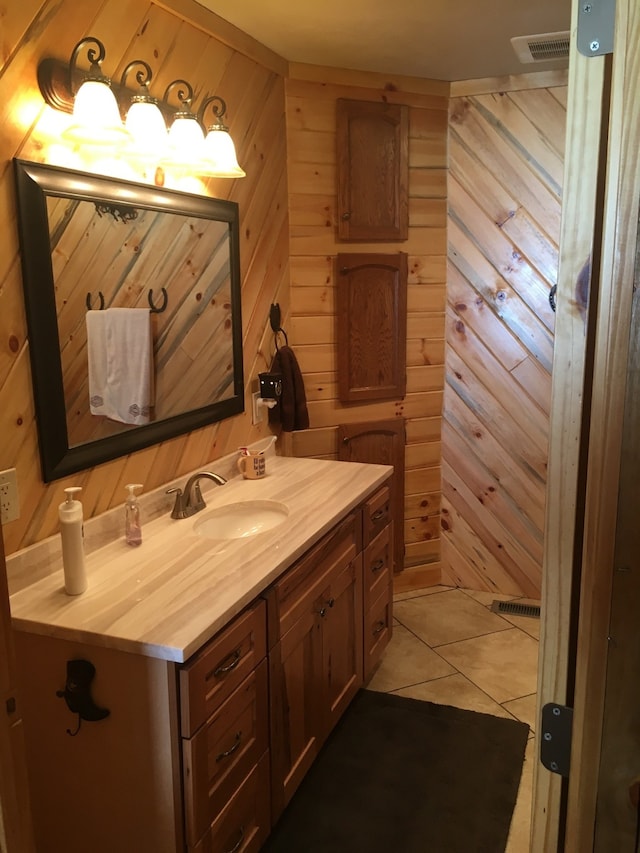 bathroom featuring vanity, tile patterned flooring, and wooden walls