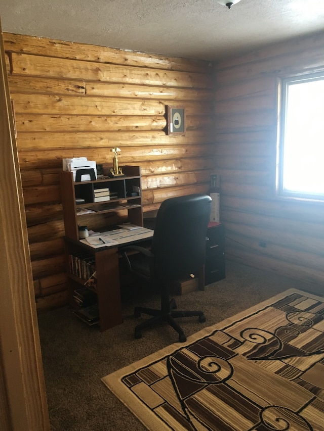 carpeted office space featuring a textured ceiling and log walls