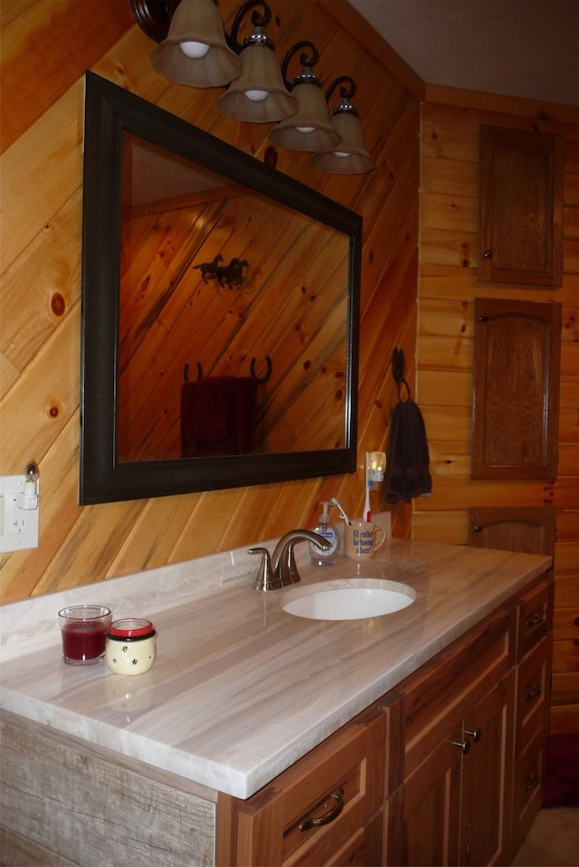 bathroom with wood walls and vanity