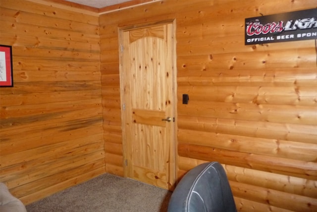 interior space featuring wooden walls and carpet floors