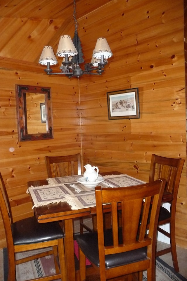 dining room featuring wood walls