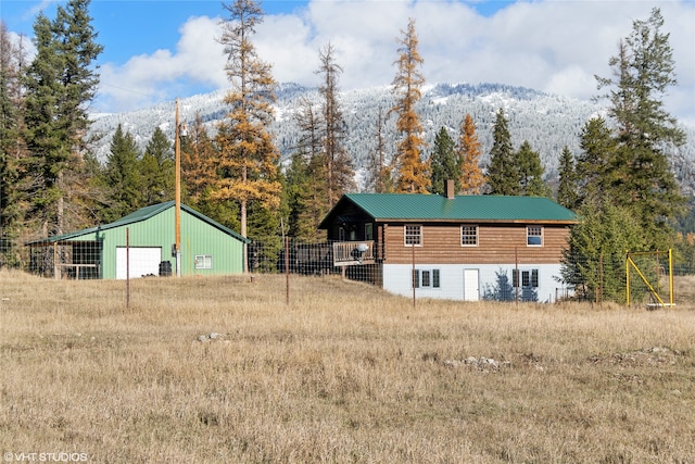 exterior space featuring a mountain view and an outdoor structure