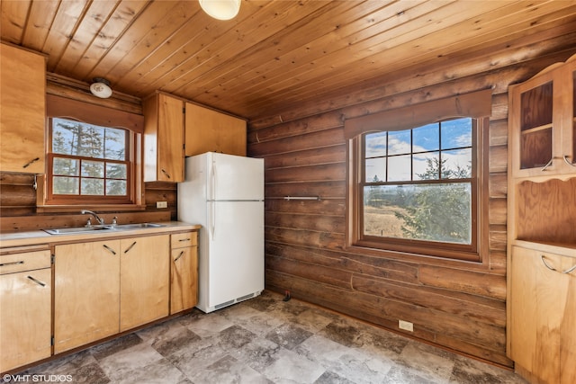 kitchen with wooden ceiling, white fridge, and sink