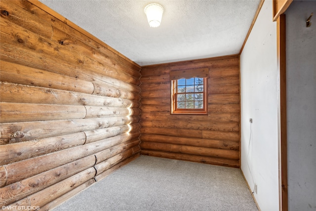 spare room with carpet, a textured ceiling, and log walls