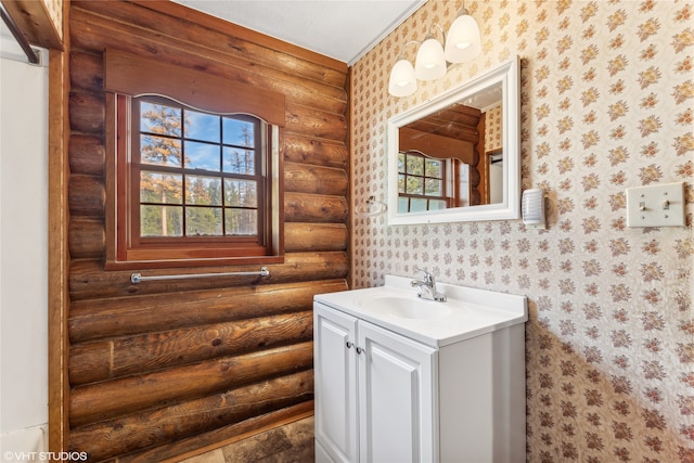 bathroom featuring vanity and log walls