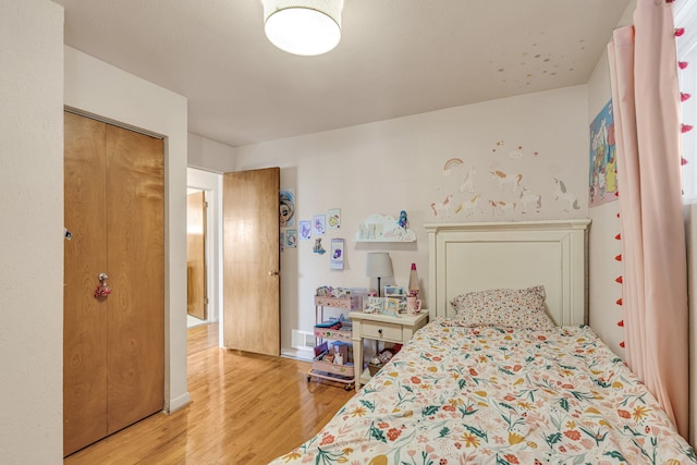 bedroom with a closet and wood-type flooring