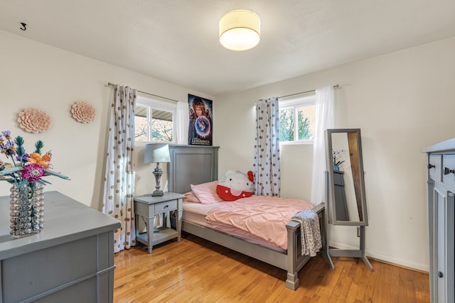 bedroom featuring light hardwood / wood-style floors and multiple windows