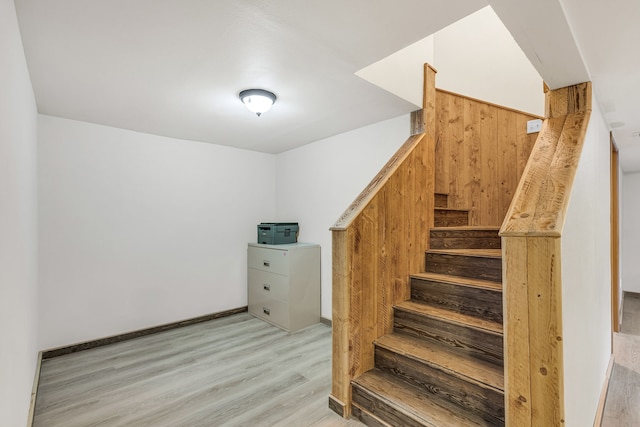 stairs featuring hardwood / wood-style floors