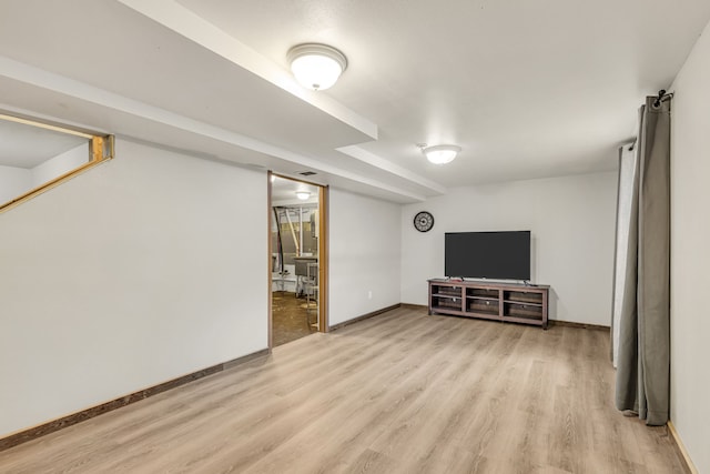 basement with light hardwood / wood-style flooring