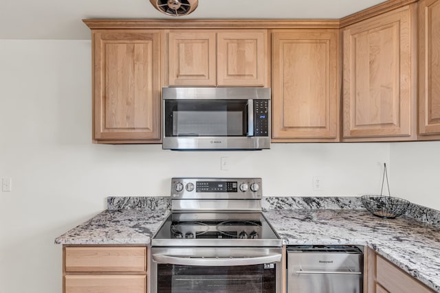 kitchen featuring light stone countertops, light brown cabinetry, and appliances with stainless steel finishes