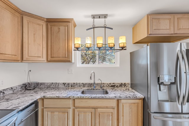 kitchen with light stone counters, hanging light fixtures, sink, appliances with stainless steel finishes, and light brown cabinetry