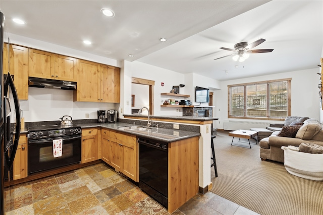 kitchen with kitchen peninsula, black appliances, sink, a breakfast bar area, and ceiling fan