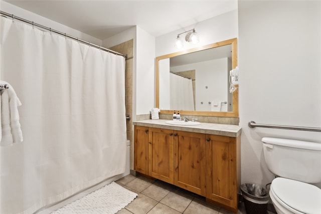 bathroom featuring toilet, vanity, and tile patterned flooring