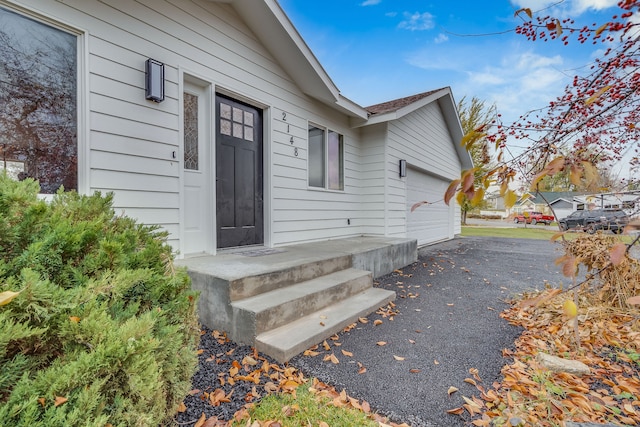 doorway to property with a garage